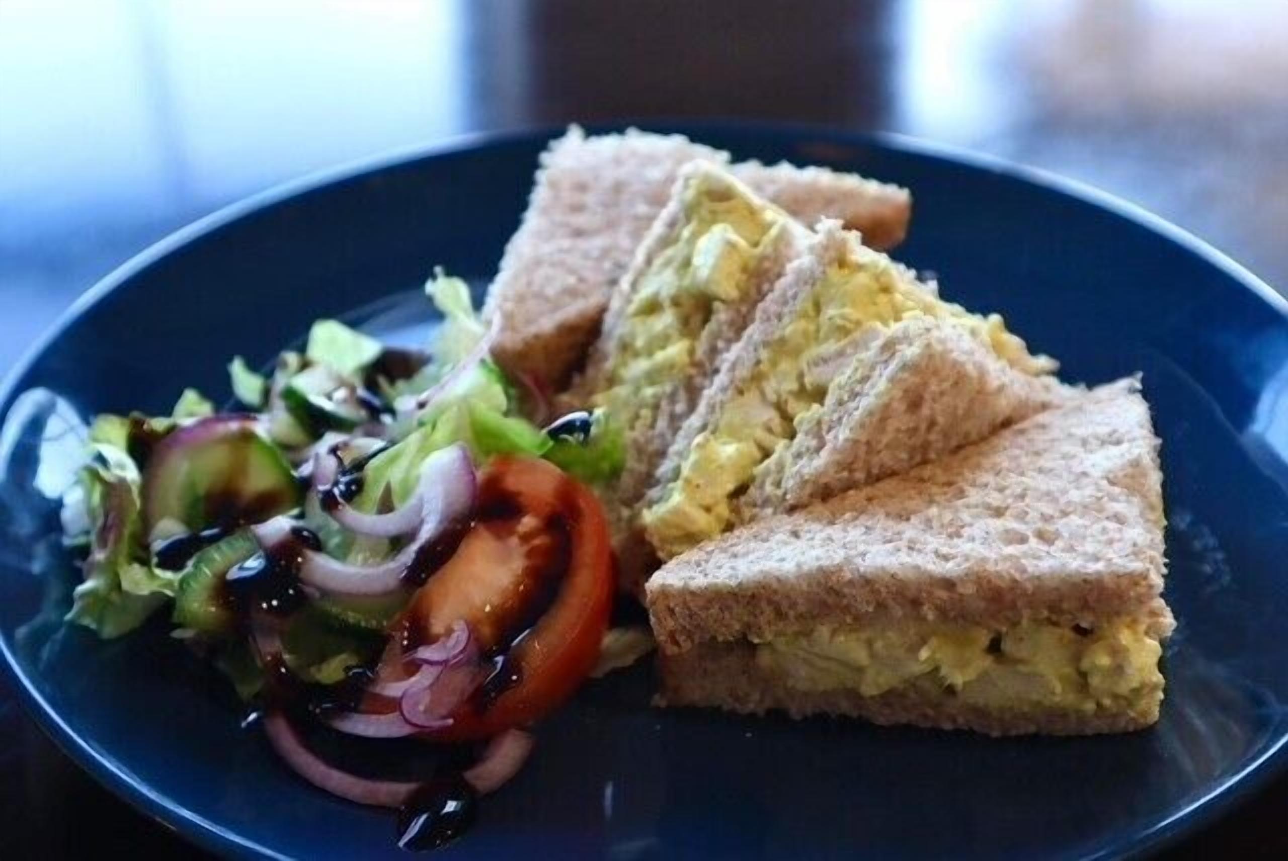 A plate with a sandwich and a salad.