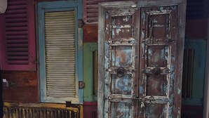 A room with a large, rustic door, a radiator, and colorful shutters. - Charter House (Newport)