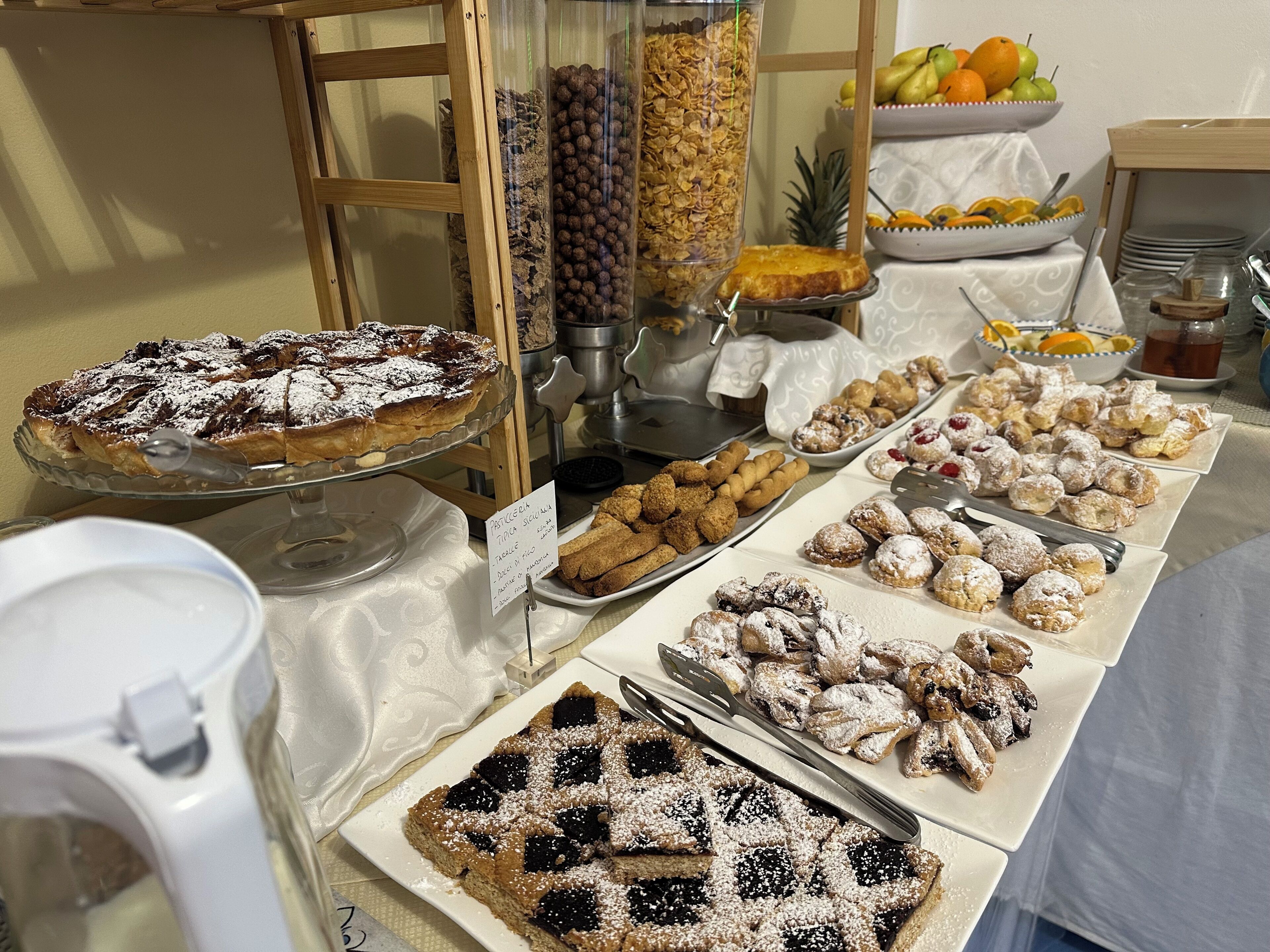 A buffet with various desserts and fruits.