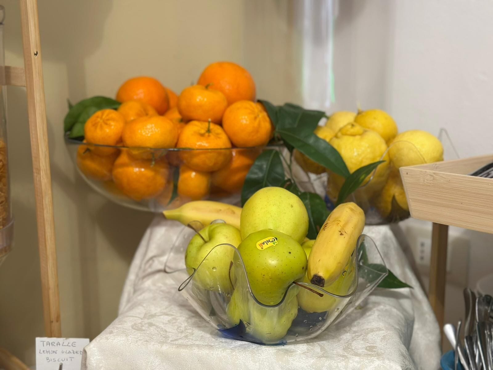 A fruit display with oranges, lemons, and bananas.