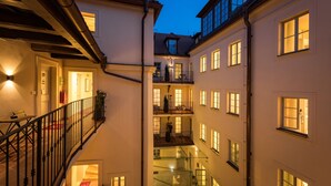 A multi-story building with a central courtyard, balconies, and multiple windows. - Old Royal Post Boutique Hotel & Premium Suites (Prague)