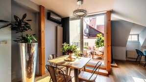 A dining area with a wooden table, metal chairs, and a potted plant. - Old Royal Post Boutique Hotel & Premium Suites (Prague)