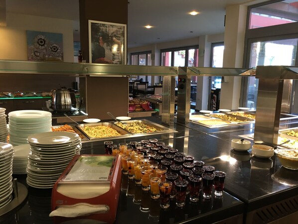 A buffet area with various food options and beverages. - TM Deluxe Hotel (Sunny Beach)