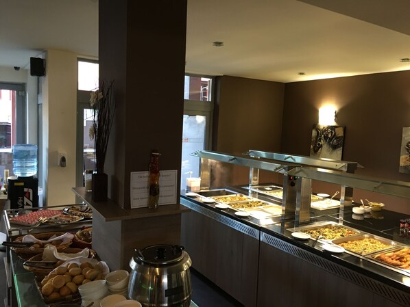A buffet area with various food options, a water dispenser, and a coffee station. - TM Deluxe Hotel (Sunny Beach)