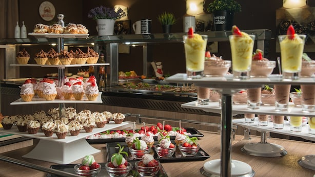 A buffet with various desserts and beverages. - TM Deluxe Hotel (Sunny Beach)