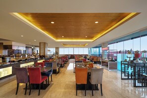 A spacious restaurant with a high ceiling and modern decor.