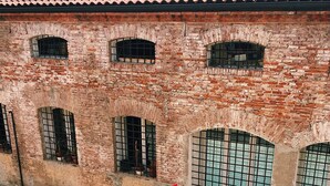 A brick building with arched windows and a tiled roof.
