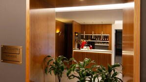 A wooden reception desk with a plaque indicating the location of the breakfast room and parking.