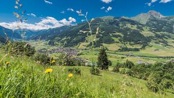 A panoramic view of a mountainous landscape with a small village nestled in the valley.