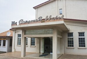 The Congress Hotel with a prominent entrance, large windows, and a tiled roof. - The Congress Hotel (Accra)