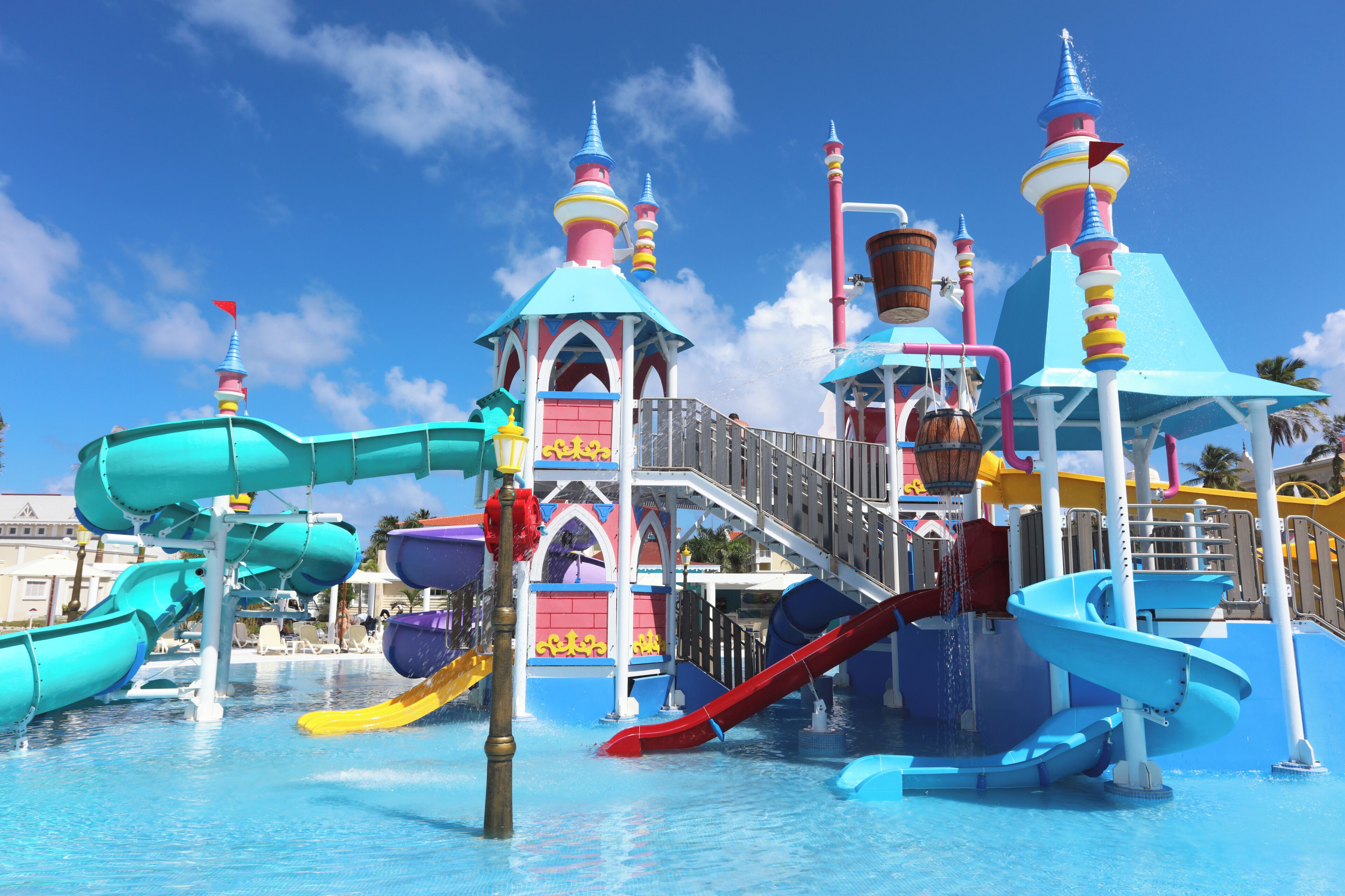 A water park with multiple slides and a castle-like structure.