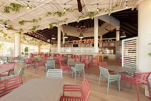 An indoor dining area with tables and chairs, a counter with a menu, and a sign that reads 'THE TRUCK'.
