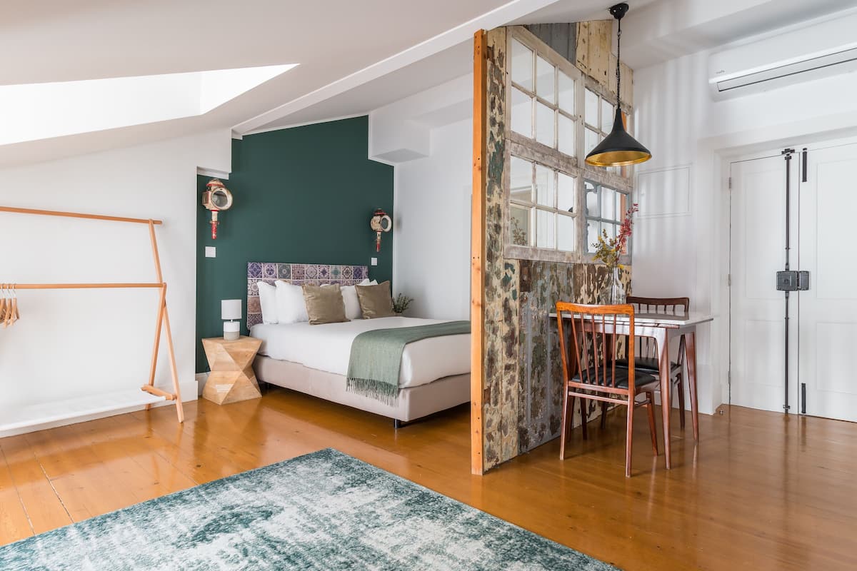 A modern bedroom with a bed, a desk, and a chair.