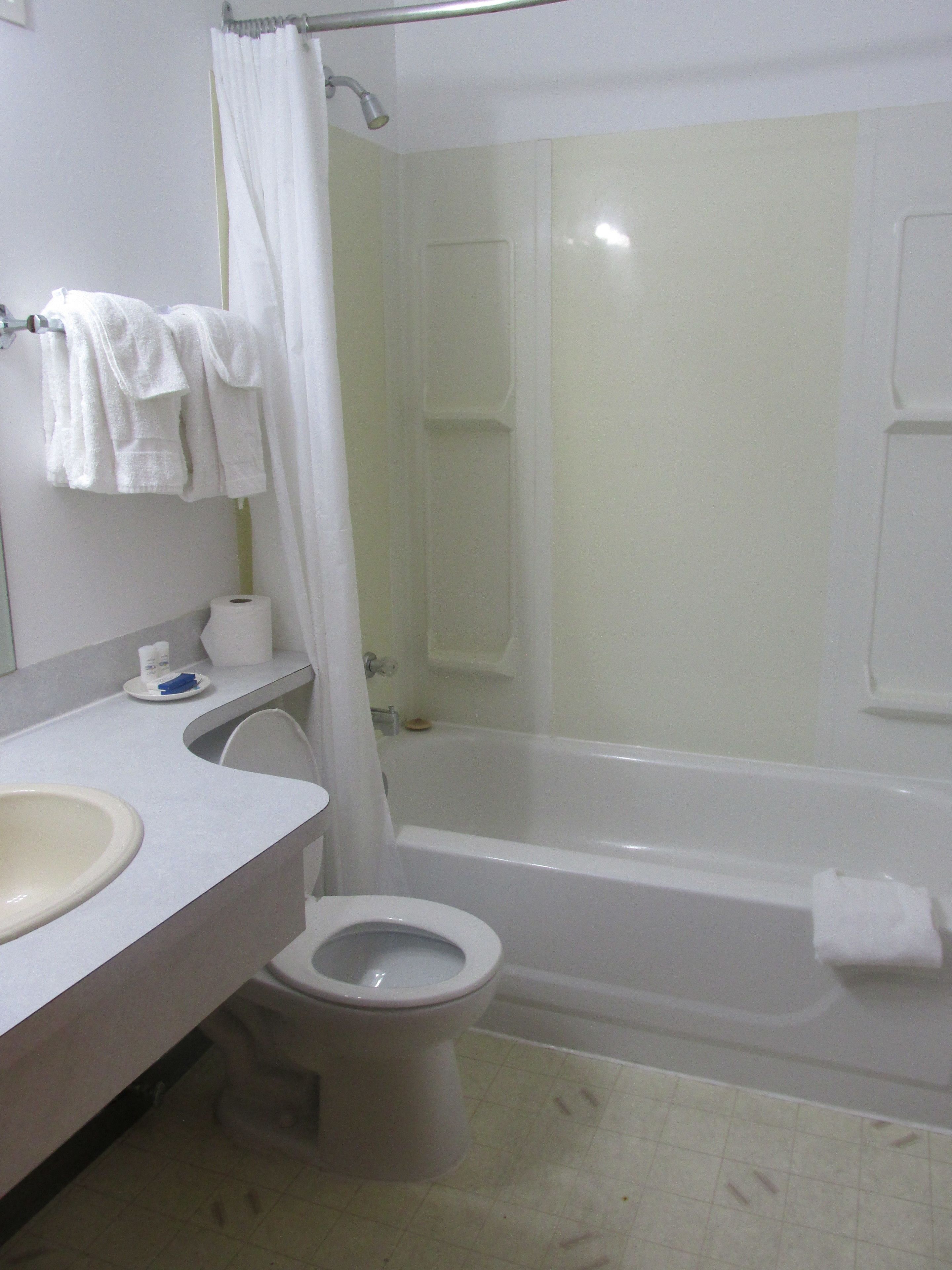 A bathroom with a toilet, sink, and bathtub.