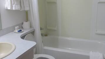 A bathroom with a toilet, sink, and bathtub.