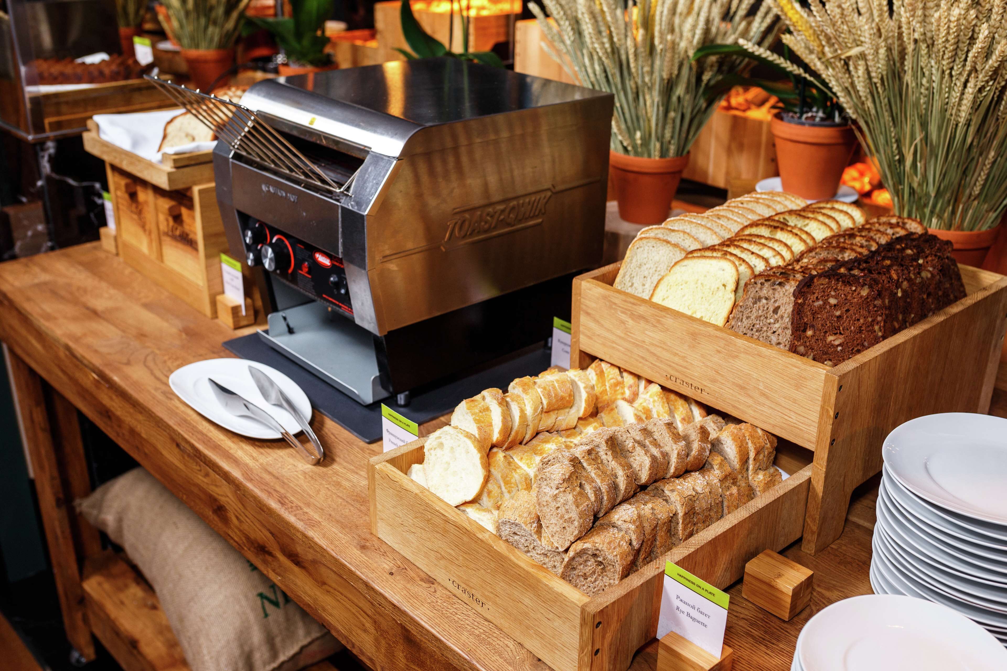 A bakery display with various types of bread and a toaster oven.