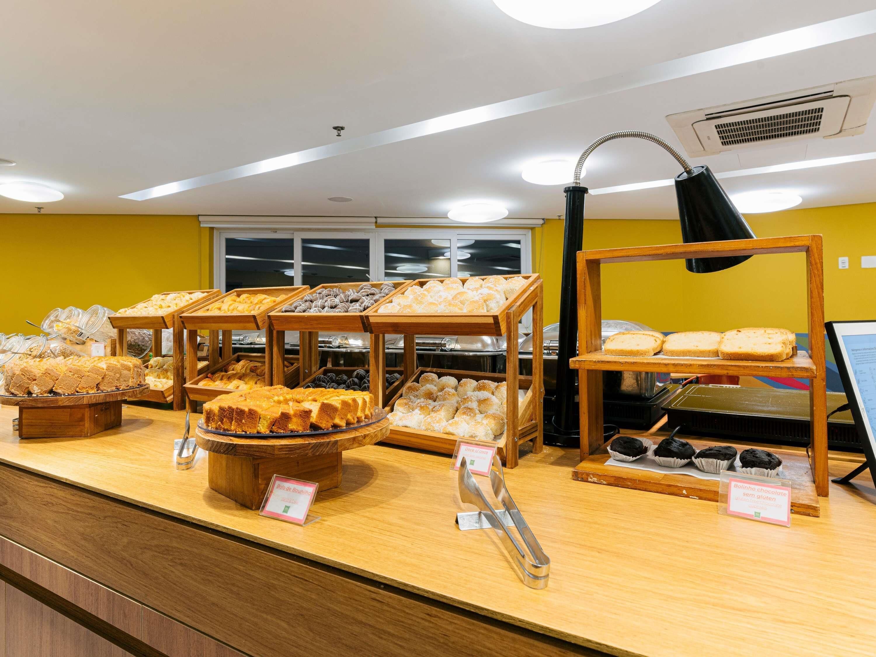 A buffet with various baked goods and a coffee station.