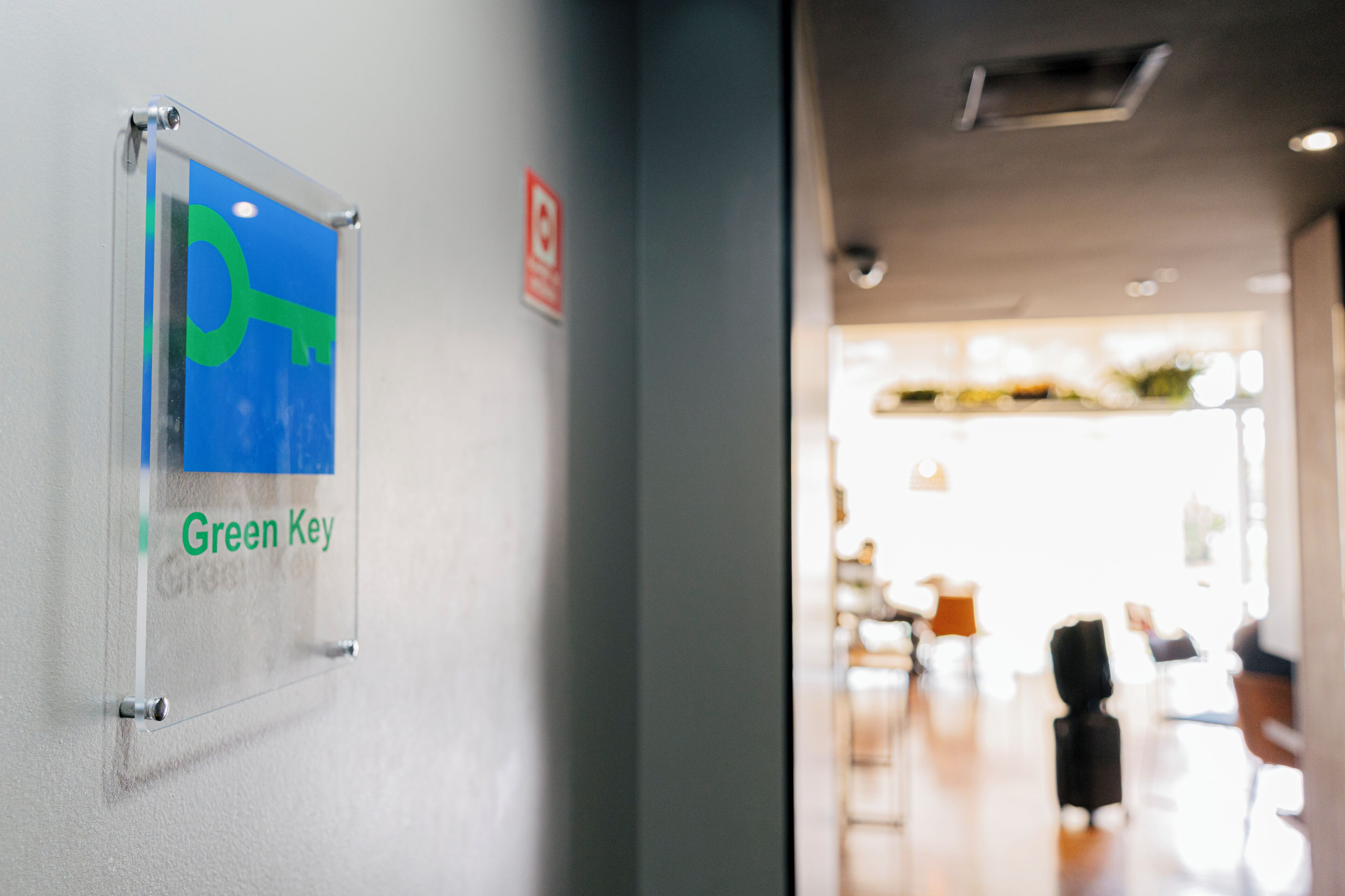A corridor with a sign reading 'Green Key' on the wall.