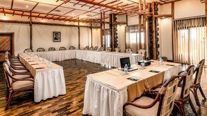 A conference room with a long table, chairs, and a laptop.
