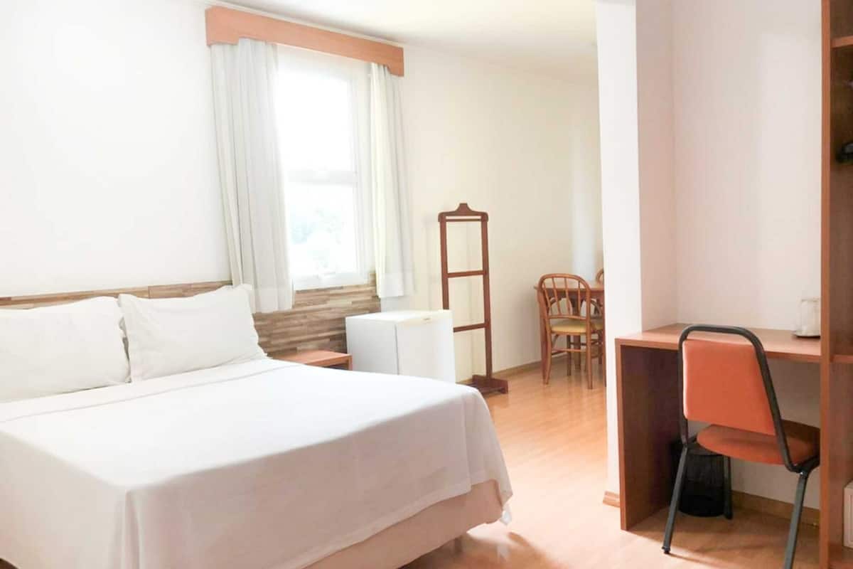 Standard Double Room | Minibar, in-room safe, desk, blackout drapes
