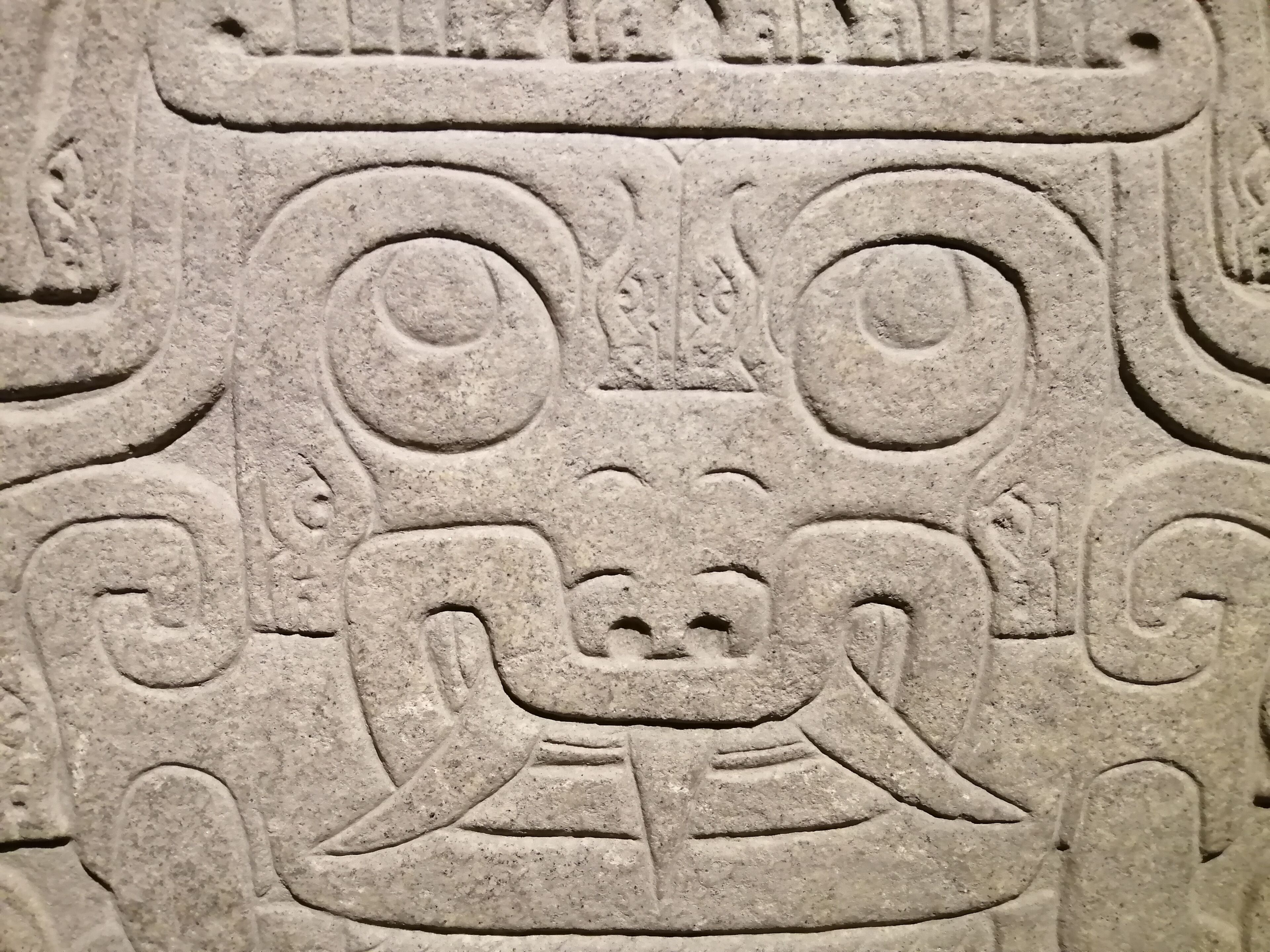 A stone carving with intricate designs, likely part of a historical or cultural site.