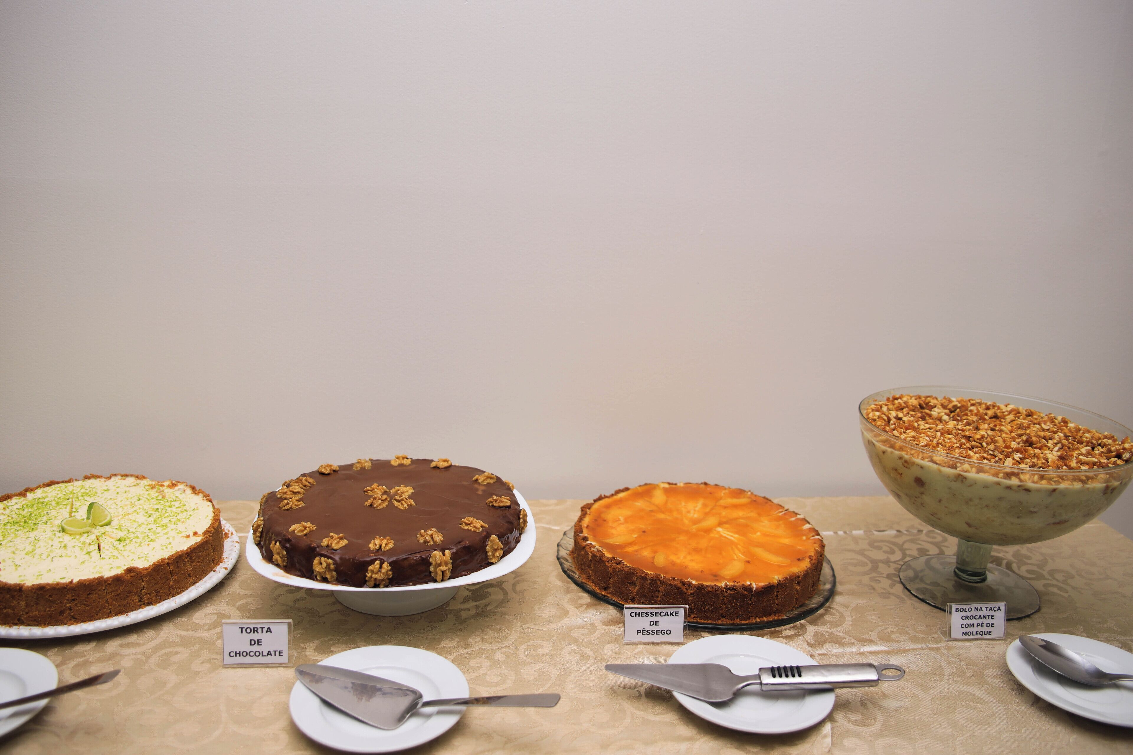 Trois gâteaux sur une table, chacun étant accompagné d’une étiquette.