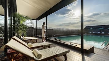 Seasonal outdoor pool, open 9:00 AM to 9:30 PM, pool umbrellas