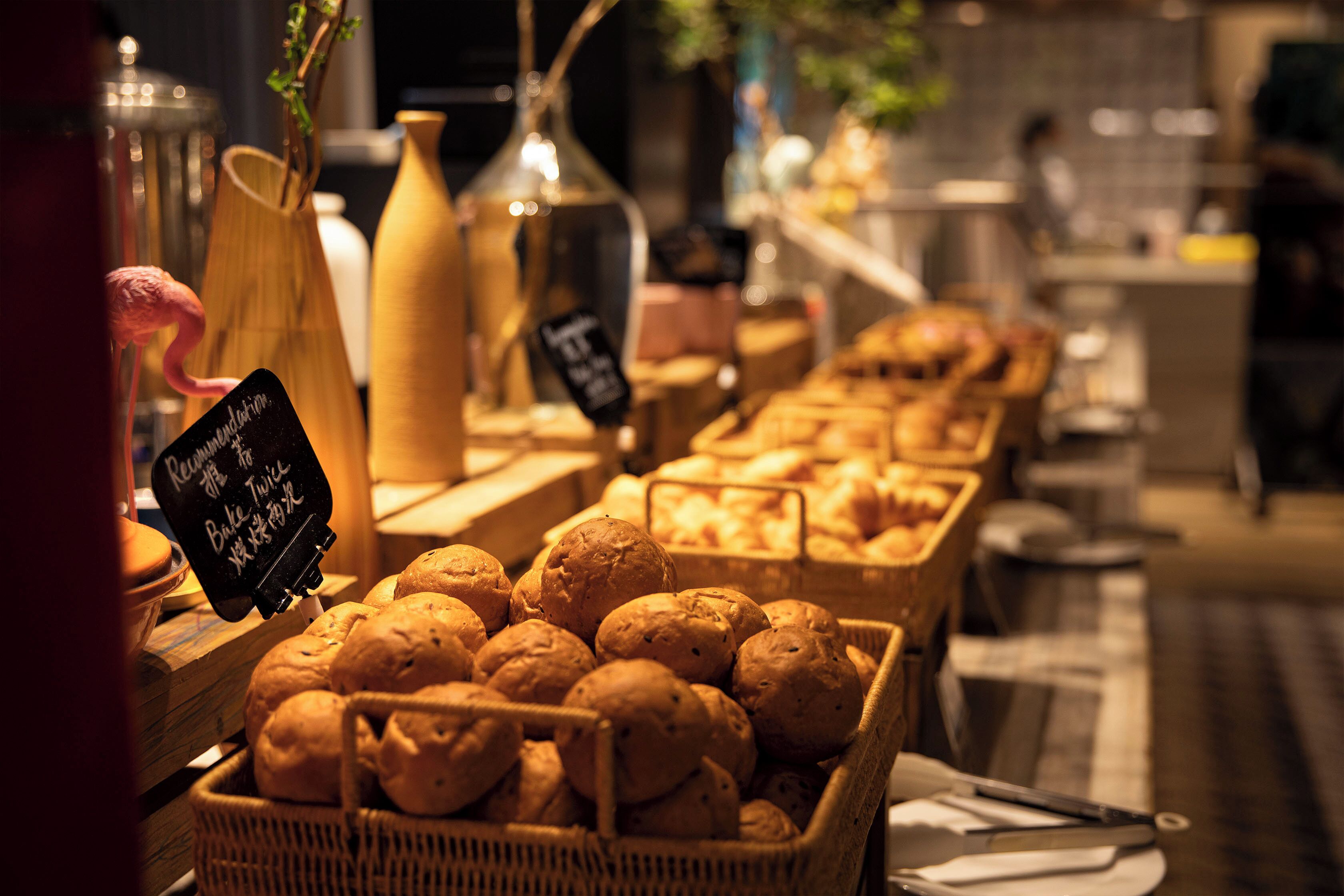 A bakery display with bread baskets and a sign indicating a special offer.