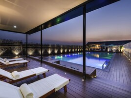 Seasonal outdoor pool, open 9:00 AM to 9:30 PM, pool umbrellas
