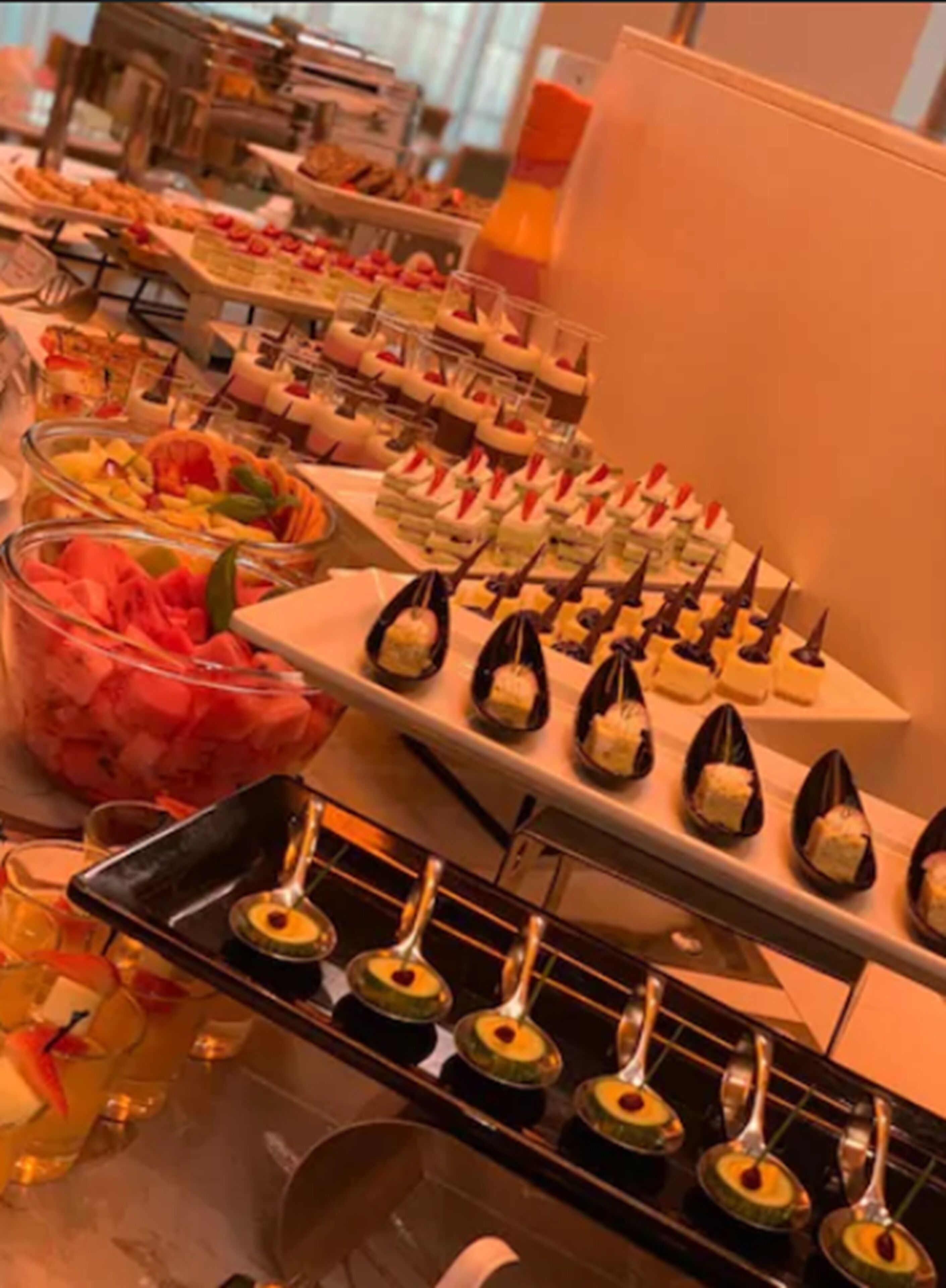 A buffet with various food items and drinks.