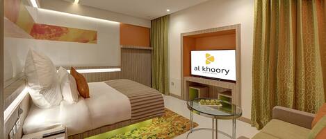 A modern hotel room with a large bed, a glass coffee table, a sofa, and a TV displaying the hotel name.