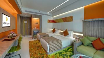 A modern hotel room with a bed, a sofa, a desk, and a TV.