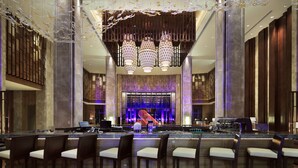 A spacious lobby with a bar area, multiple seating arrangements, and a large decorative chandelier. - Pullman Nanchang Sunac (Nanchang)