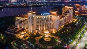 A hotel with a prominent 'Pullman' sign, surrounded by a landscaped area and a parking lot. - Pullman Nanchang Sunac (Nanchang)