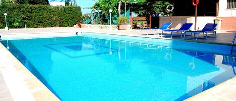 Outdoor pool, open 8:00 AM to 7:00 PM, pool umbrellas, pool loungers