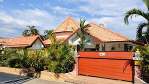 A residential area with houses featuring red-tiled roofs and brick walls.