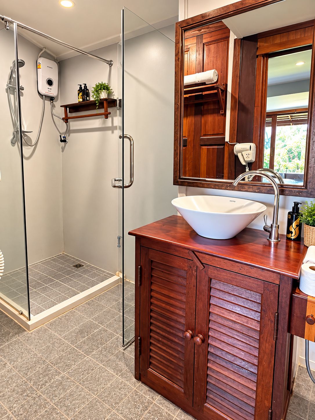 A bathroom with a glass-enclosed shower, a white sink, and wooden cabinetry.