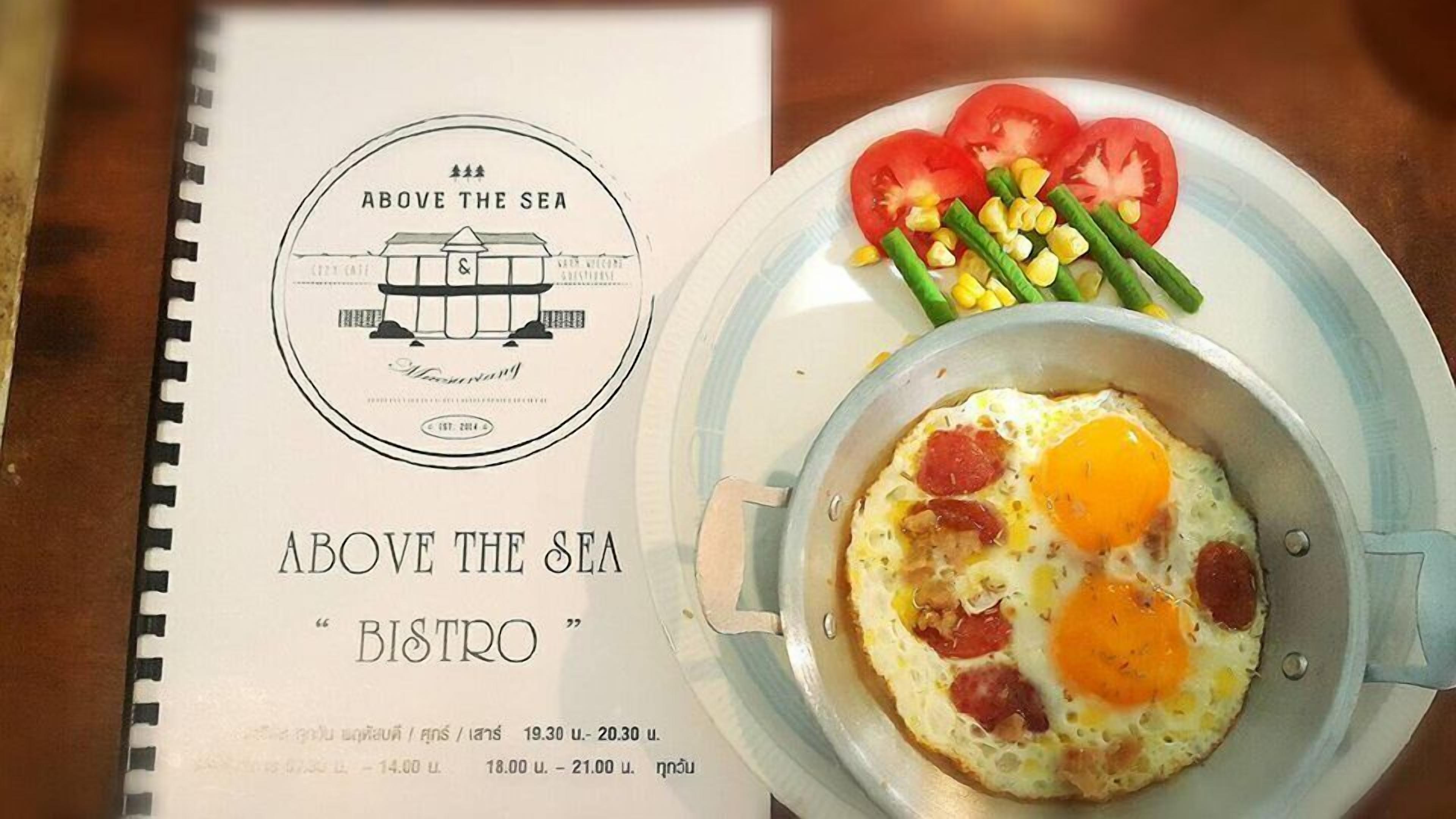 A menu titled "Above the Sea Bistro" with a breakfast dish of eggs, tomatoes, and corn.