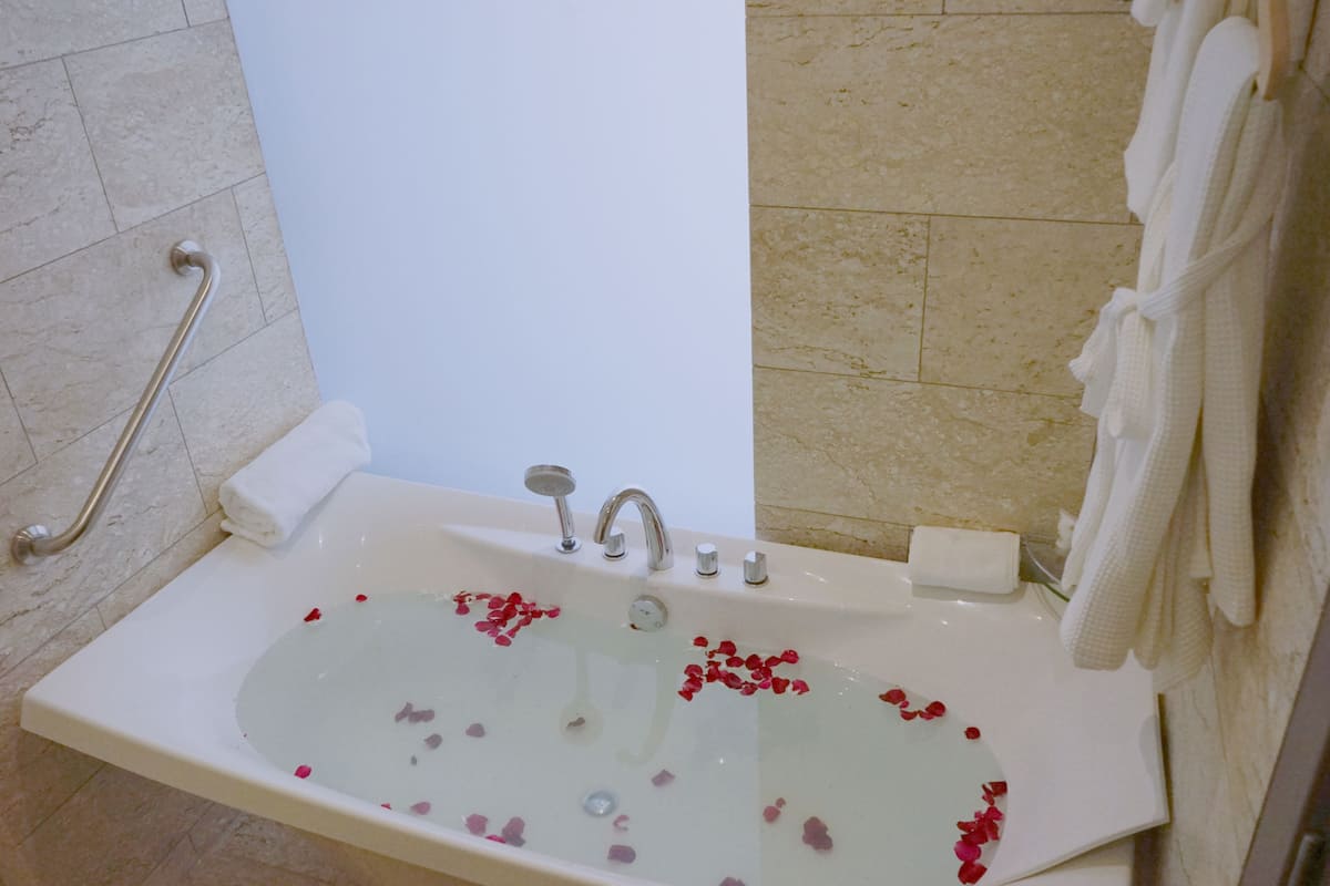 deluxe river view room with bathtub | bathroom | free toiletries, hair dryer, bathrobes, slippers