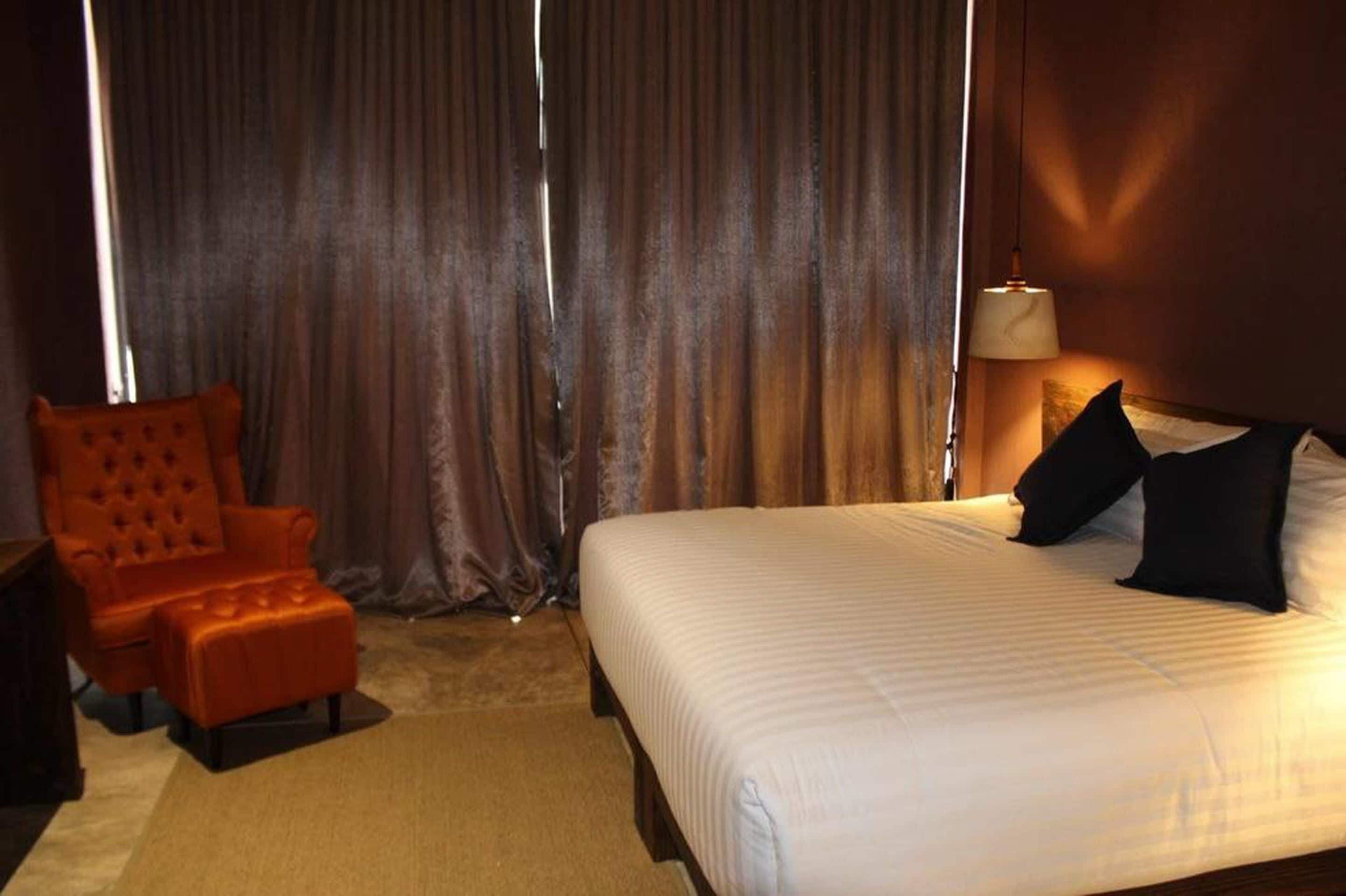 deluxe river view room | premium bedding, minibar, desk, laptop workspace