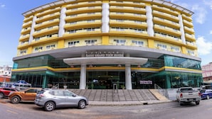 A multi-story hotel with a curved facade, large glass entrance, and a prominent sign reading "SATT GRAND VIEW HOTEL". - Satit Grand View Hotel (Sadao)