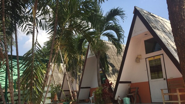 A bungalow with a sloped roof, a small porch, and steps leading to the entrance. - Sam's House Guesthouse (Kanchanaburi)