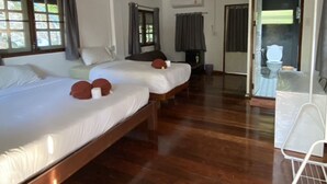 A hotel room with two beds, wooden flooring, a bathroom with a shower, and a view of the outdoors. - Sam's House Guesthouse (Kanchanaburi)