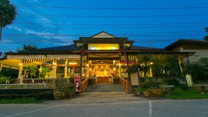A traditional building with a tiled roof, a central entrance with steps, and potted plants around the entrance. - Forra Hill Resort (Mueang Loei)