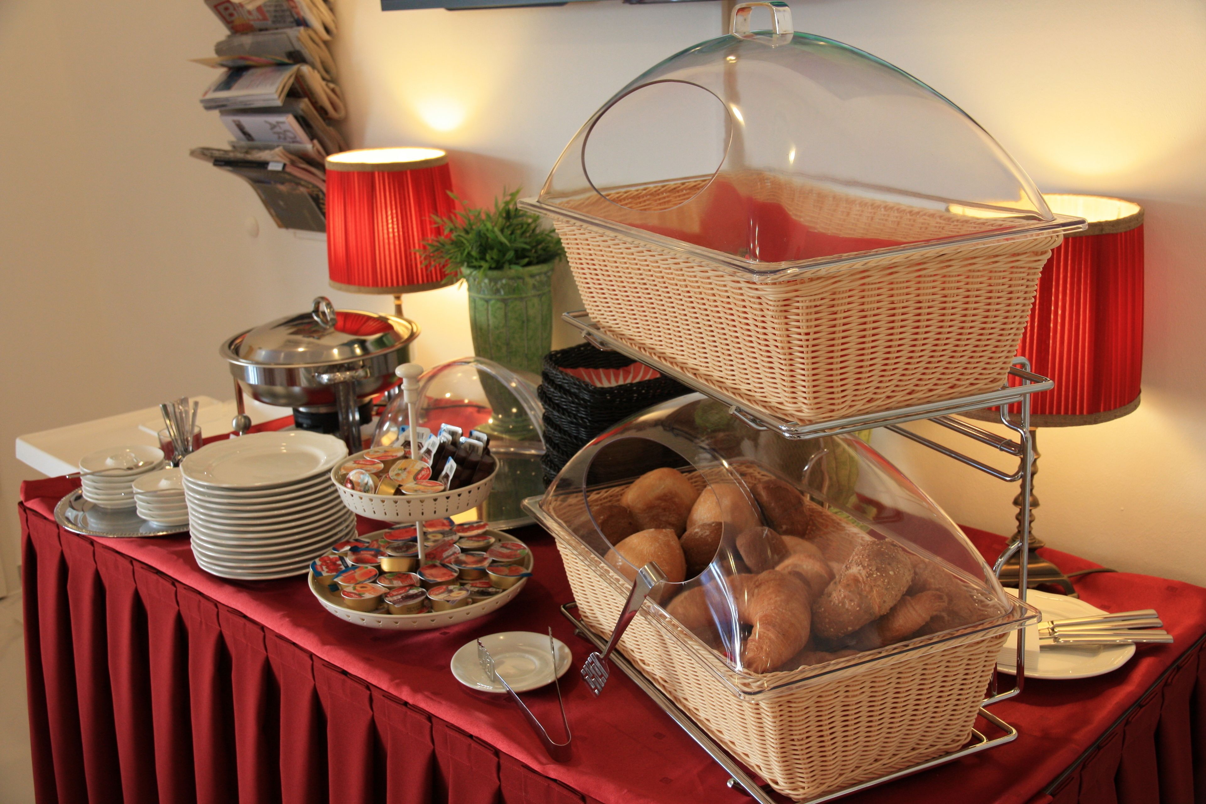 A buffet table with various food items and serving utensils.