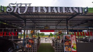 The entrance to Sky Restaurant with a covered outdoor seating area and visible food advertisements. - Sky Resort (Kanchanaburi)
