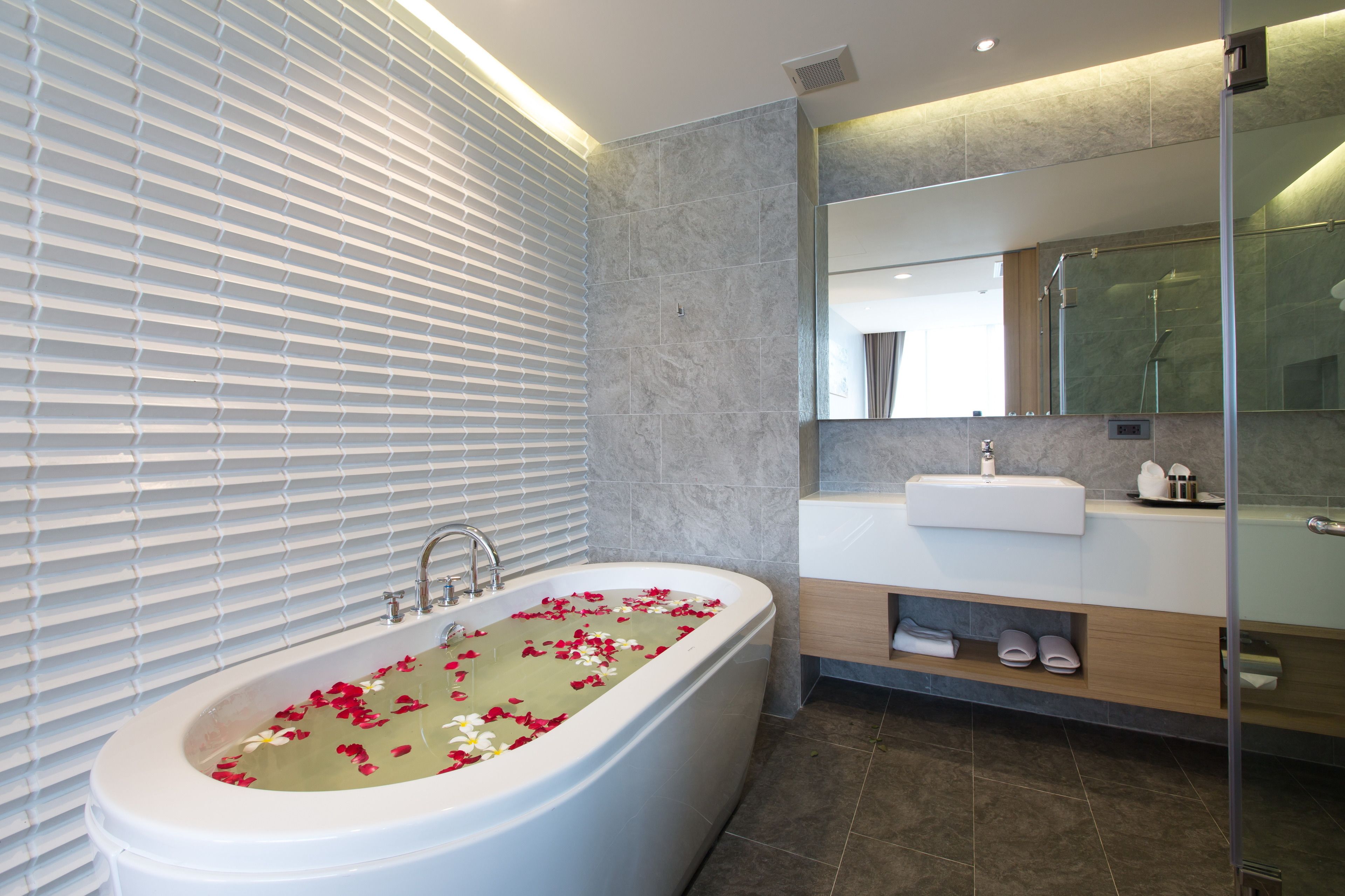 one-bedroom suite | bathroom | rainfall showerhead, free toiletries, hair dryer, bathrobes