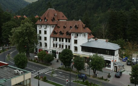 A hotel with a traditional architectural style, featuring multiple stories and a prominent entrance.
