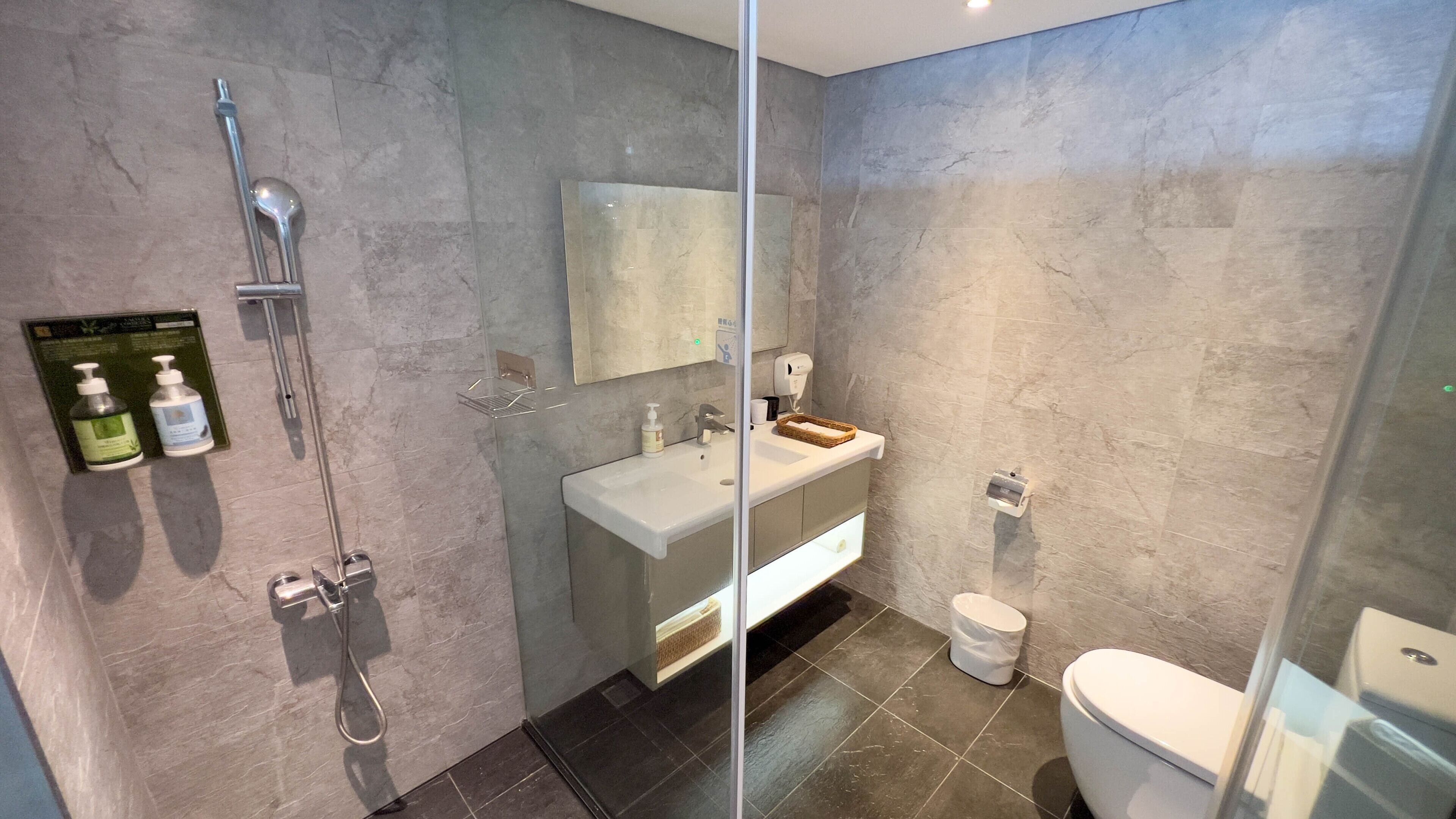 shower, hair dryer, slippers, towels