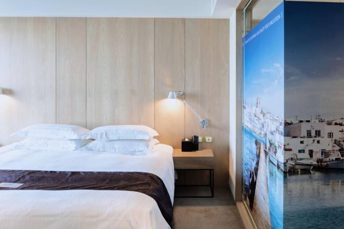 Premium bedding, desk, laptop workspace, blackout drapes